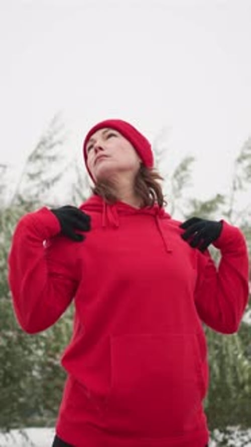 Woman Stretching Arms Outside in Winter Landscape