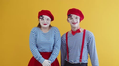 Two Mimes Wearing Silly Glasses Smiling and Laughing