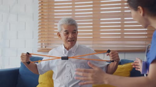 Senior Man Exercising with Resistance Band at Home