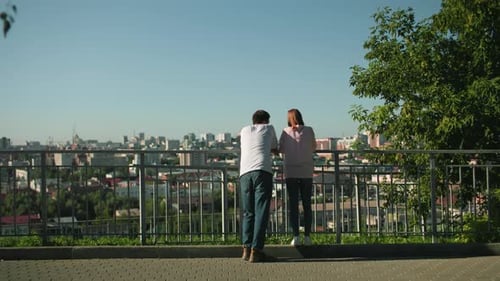 Man and Woman Looking Over the City