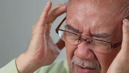 Senior Man Massaging Temples Suffering Headache Pain