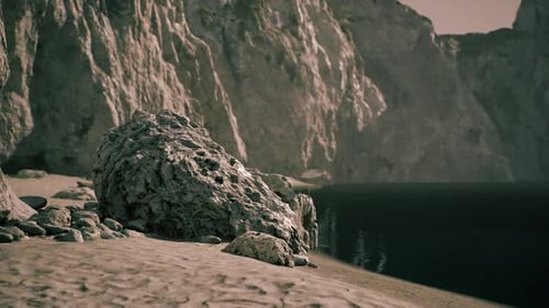 Stunning Rocky Coastline with Calm Water and Sandy Beach at Sunset