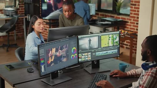 Video Editors Working Together in Office Environment