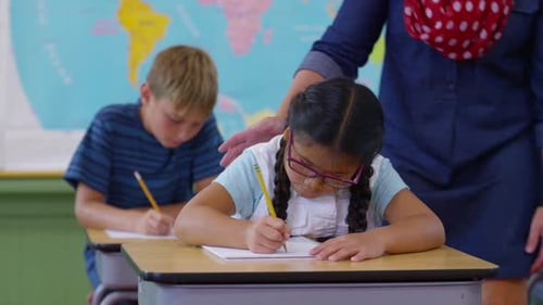 Teacher Helping Students in School Classroom Asian