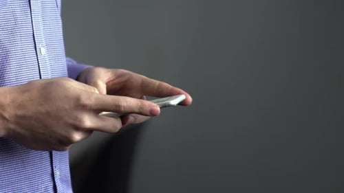 Hands Using a Mobile Phone Indoors