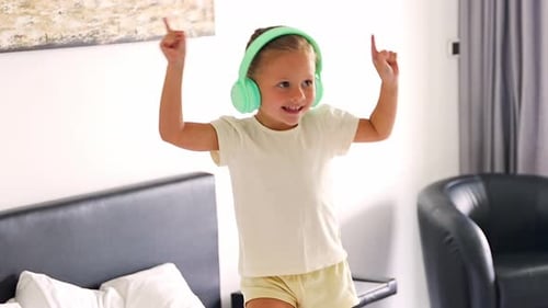 Energetic Girl Dancing with Headphones Indoors