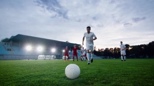 Soccer Players Training on Field at Stadium
