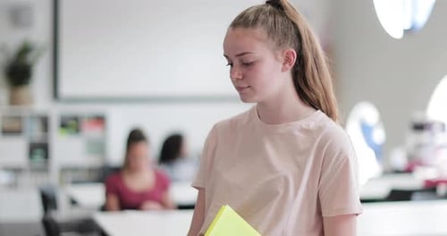 Portrait of female high school student in class