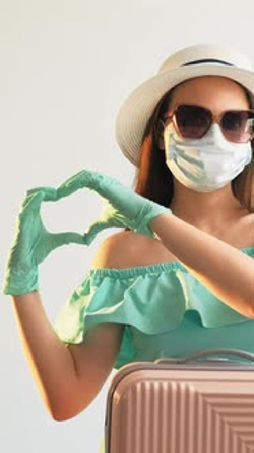 Woman with Mask and Gloves Makes Heart Shape