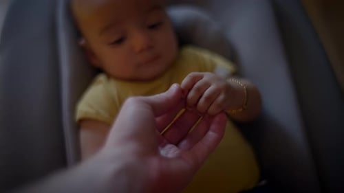 Baby Hand Held by an Adult Hand