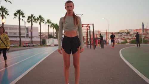 Athletic Woman Stands Still on Outdoor Track