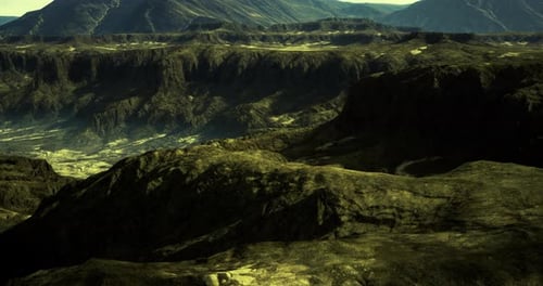 Aerial View Flying Through Dark Rocky Mountain Landscape