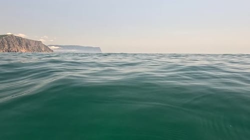 Sea Water Surface Background Low Angle View From Kayak Camera Flies Over the Clear Green Sea Water