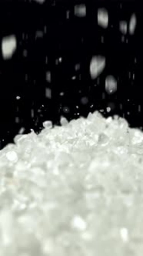 Salt Crystals Fall Into a Pile Filmed on a Highspeed Camera at 1000 Fps