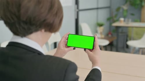 Old Businesswoman Holding Smartphone with Green Screen