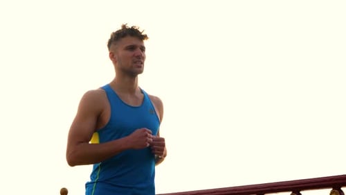 Close Up Portrait of Young Handsome Athletic Male in Sportswear Runs Outdoor