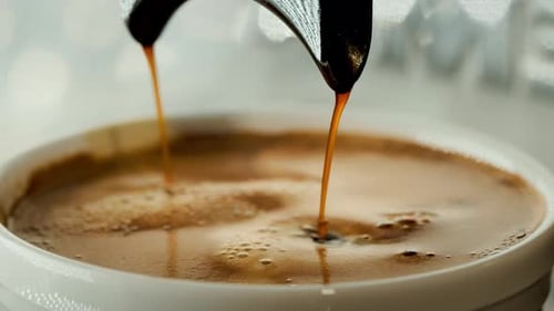 Espresso Pouring Into Cup Close Up