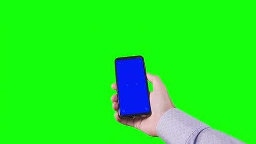 Male Hand Holding Smartphone with Blue Screen with Markers on Green Background