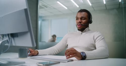 Young Man Working at Computer in Modern Office