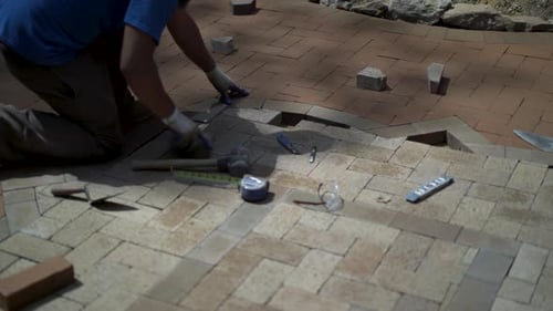 Man Laying Bricks for Walkway Construction
