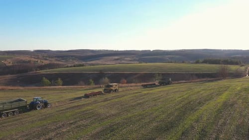 Flying Over Agricultural Machinery Driving on Country Road After Finishing Work on Farmland
