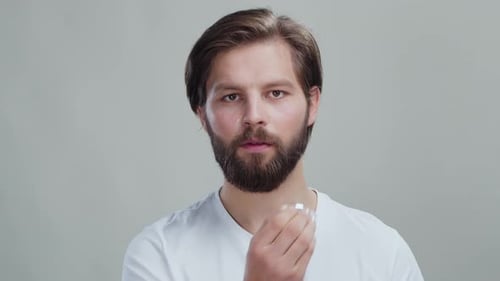 Man Applying Face Serum for Skin Care Routine