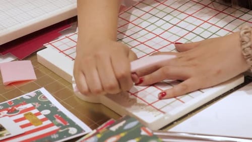 Hand Crafting Holiday Card on White Table