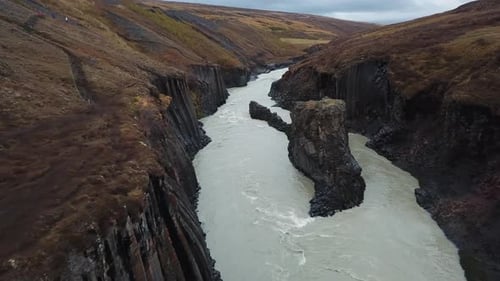 Steep Volcanic Basalt Rock Canyon and Glacial River in Highlands of Iceland, Crazy Unique Landscape
