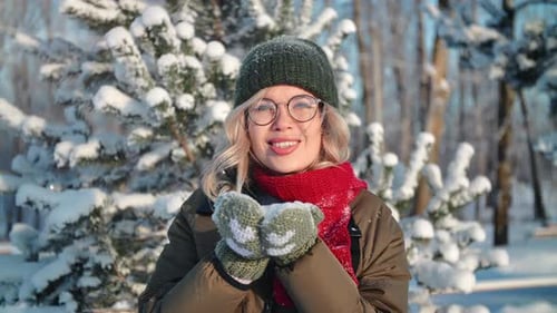 Portrait Smiling Woman Blowing Snowflakes Snow Particles at Sunny Winter Forest Closeup Slow Motion