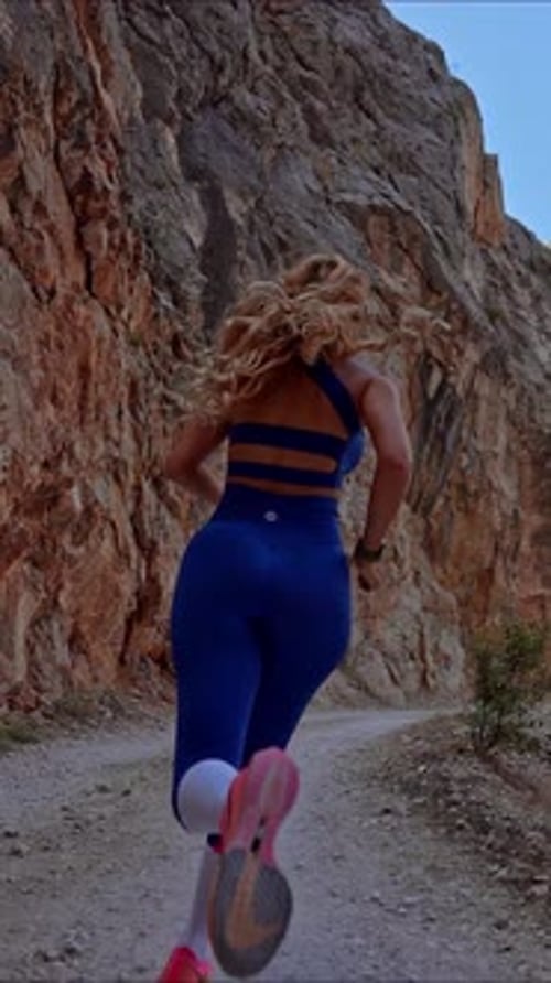 Woman Runner in Narrow Canyon Path