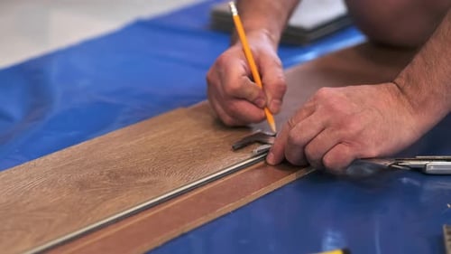 Hands Measure and Mark the Floorboard Ensuring Accuracy A Symbol of Diligent Work Ethic and