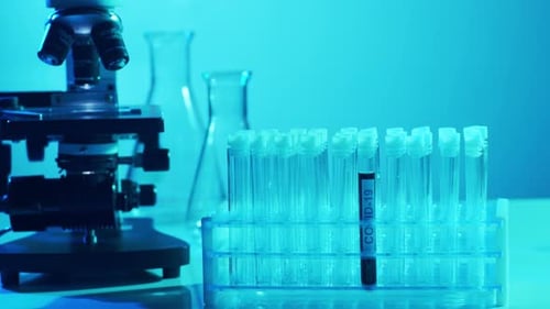 Microscope and COVID-19 Test Tubes in Lab