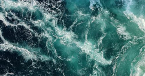 Blue waves of water of the river and the sea meet each other during high tide and low tide.