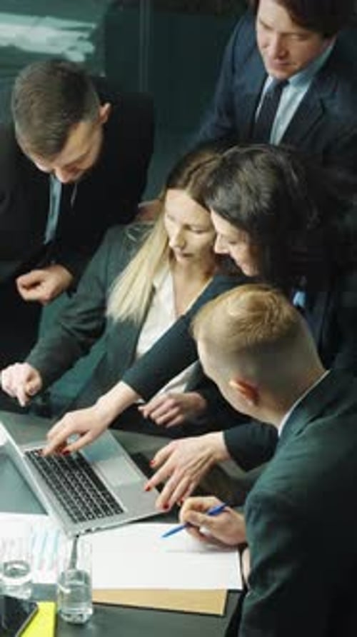 Business Team Collaborating on Laptop in Modern Office