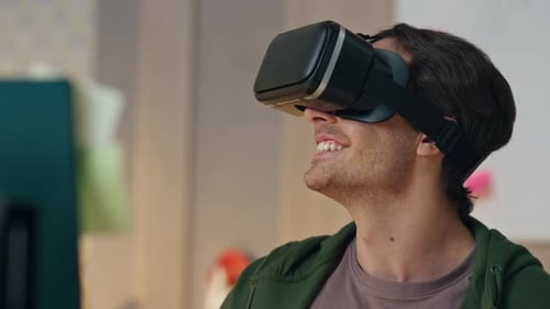 Man Smiles, Using VR Headset Indoors