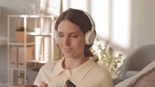 Woman Listening to Music with Headphones and Smartphone