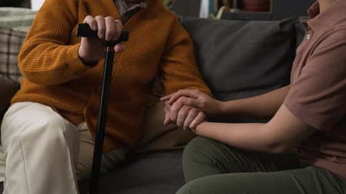 Comforting Touch: Hand Holding for Senior Woman Indoors
