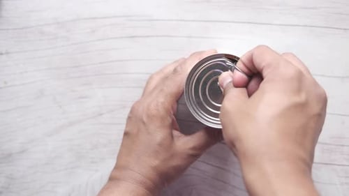 Opening a Food Can on Table Top View