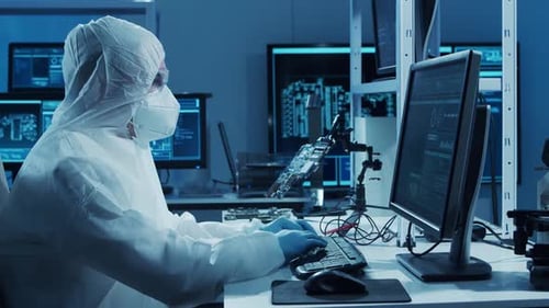 Microelectronics Engineer Works in a Modern Scientific Laboratory on Computing Systems and