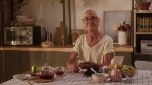 Senior Woman Relaxing in Her Kitchen with Tea
