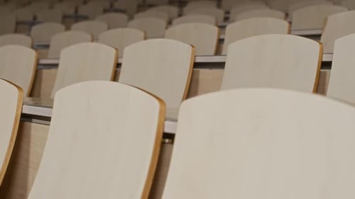 Rows of Wooden Chairs and Desks in Auditorium for Lectures