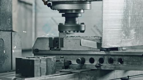 Precision metal cutting machine sparks in industrial workshop