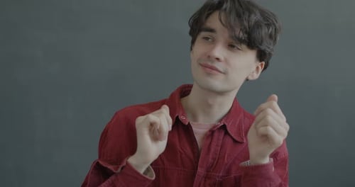 Young Man Dances to Music in Close Up