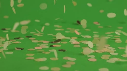 Falling confetti on a green background.