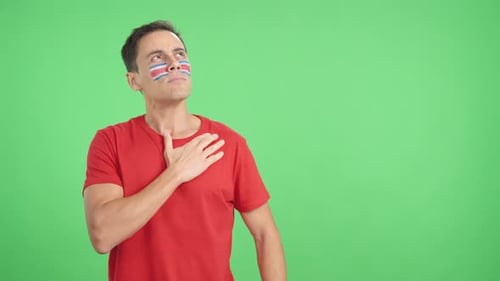 Man Listening to the Costa Rica National Anthem with Solemnity