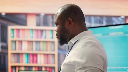 Adult Man Giving Corporate Presentation at Workplace