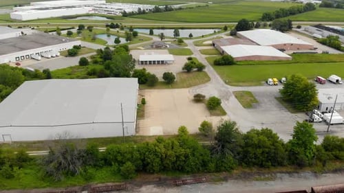 4k aerial reveal of multiple trains as they are stationary at a train station
