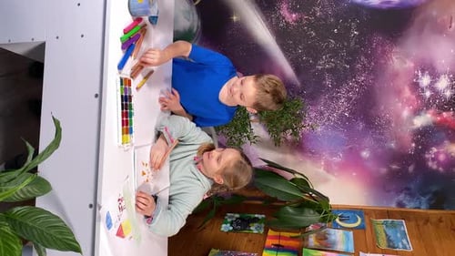 Children Drawing Pictures at Table in Home Studio