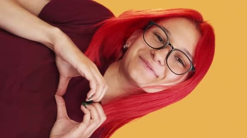 Joyful Woman Making Heart Shape with Hands