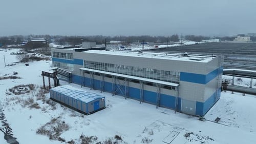 Treatment Plant Building Stands Beside Hangar Structure